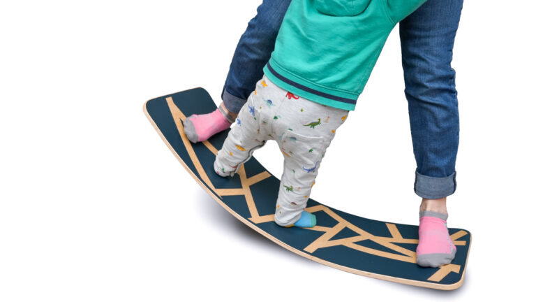 Child Playing on DIY Balance Board with Mom