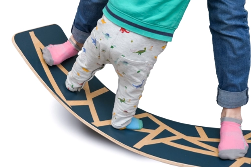 A child and mom on a Balance Board that they made themselves. A fully build video available at Makers Manual.